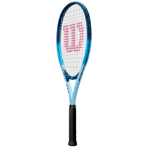 A tennis racket with a blue frame and a white string bed is positioned vertically with a black grip. The logo "Wilson" is prominently displayed in red within the string area.