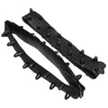 Two black rubber straps with pointed spikes arranged along their length lie on a flat surface with one strap curved and the other more elongated and straight.