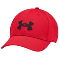 A red baseball cap features a prominent black Under Armour logo on the front and has a curved brim, designed for casual wear or sports activities.