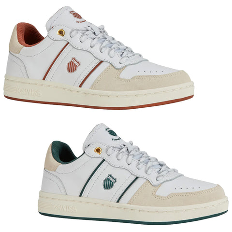 A white sneaker with green accents and a suede toe features laces and a logo on the side, positioned on a neutral background, showcasing its sporty design.