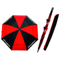 A large red and black umbrella is open with eight segments displaying alternating colors while a folded version with a matching cover rests beside it in a neutral setting.