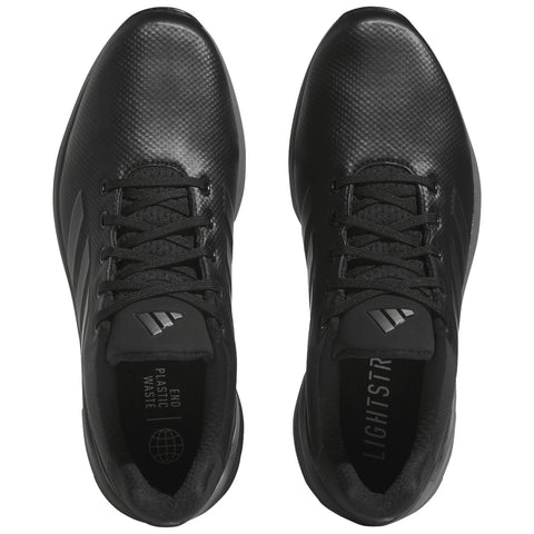 Black athletic shoes are displayed from above with laces tied each shoe features a textured surface and branding visible inside including the text END PLASTIC WASTE and LIGHTSTR.