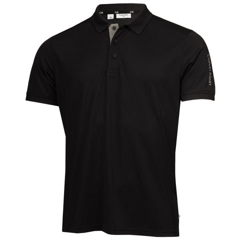 A black polo shirt with a gray collar and three buttons is displayed frontally featuring short sleeves and a logo on the sleeve showcasing a simple and modern design.