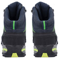 High-top athletic shoes display thick soles and a dark blue upper with green accents. They are positioned upright against a plain background, showcasing their design and structure.