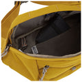 A yellow bag is open displaying its interior containing a black item and a tag labeled RFID guard showcasing its organizational features in a casual setting.