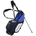 A blue and black golf bag with multiple pockets and adjustable straps stands upright on a retractable stand ready for use on a golf course setting.