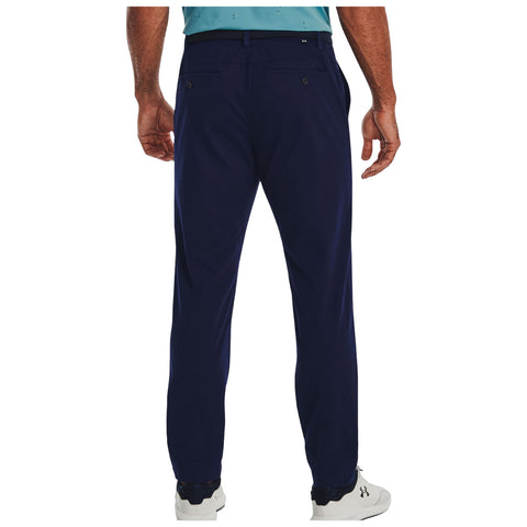 Navy blue golf chinos are worn by a person standing with their back to the viewer, displaying a smooth fabric texture and double back pockets. The look is ideal for a casual yet polished golfing outfit.