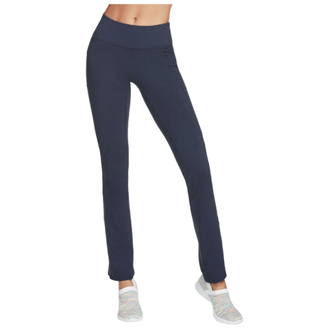 Navy blue leggings with a high waistband are being worn by a person standing upright with a relaxed pose in a neutral background, complemented by colorful athletic shoes.