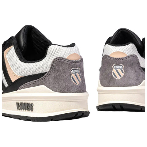 Stylish sneakers in black white and gray are positioned side by side highlighting their textured materials and logo on the heel suggesting a casual and athletic context suitable for various activities.