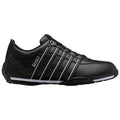 Black athletic shoe features a sleek design with three white stripes on the side and a light sole positioned on a plain background suggesting a focus on footwear for sports or casual wear.