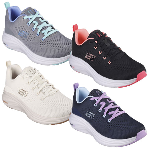 Four pairs of athletic shoes are displayed two on top and two below in various colors grey with blue accents black with coral accents cream and navy with purple accents arranged neatly on a white background