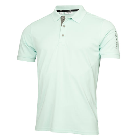 A light green polo shirt is displayed upright featuring a collared neckline and short sleeves with distinct gray detailing on the collar and a logo on the sleeve.