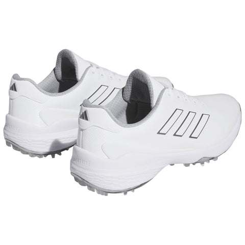 White athletic shoes with gray accents are displayed at an angle showcasing their sleek design and textured surface intended for performance sports in a neutral background