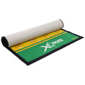 A green and yellow mat is partially rolled up showcasing a textured surface with bold white branding XQMAX and a patterned yellow background featuring circular designs in a clean setting