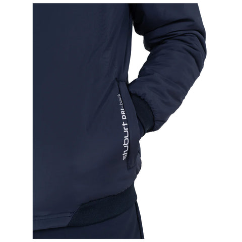 A navy jacket with a zippered pocket is being worn with a hand resting inside the pocket showcasing a comfortable and casual attire suitable for outdoor activities.