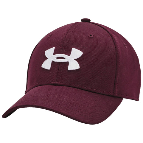 A maroon baseball cap with a prominent white Under Armour logo rests at an angle showing its curved brim and structured design against a plain background.