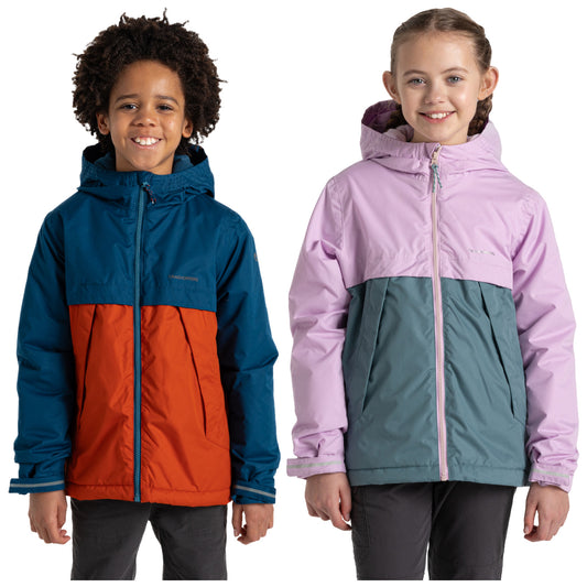 Two children stand side by side wearing colorful jackets. The boy on the left wears a blue and orange jacket and the girl on the right wears a pink and teal jacket.