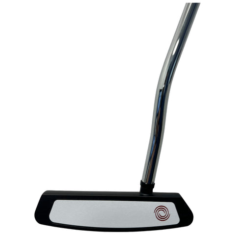 A golf putter stands upright showcasing a shiny chrome shaft and a flat black base with a silver face featuring a circular design This object is designed for precise shots on the green