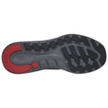 A black and gray sneaker sole with a red accent shows tread patterns designed for grip and traction on various surfaces in an athletic or casual setting.