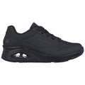 Black athletic shoe features a sleek design with a rounded toe and cushioned sole showcasing a transparent air pocket under the heel positioned on a plain background.