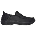 A black slip-on shoe with a smooth upper and elastic side panels is positioned against a plain background showcasing its casual design and comfort-focused style aimed at everyday wear.