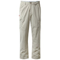 Beige cargo pants with side pockets stand upright against a plain background showcasing a lightweight fabric suitable for outdoor activities and versatility in various settings.