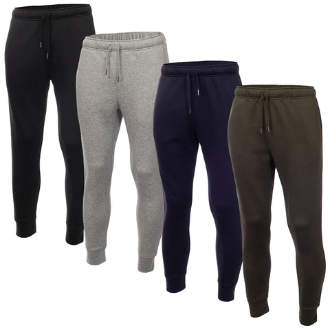 Four pairs of jogger pants are displayed in a row featuring color variations black gray navy and olive green made of soft fabric with elastic waistbands and cuffs