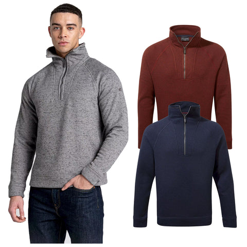 A man models a grey zip-up pullover with a high collar while two additional pullovers in dark red and navy blue are displayed beside him showcasing various sweater designs.