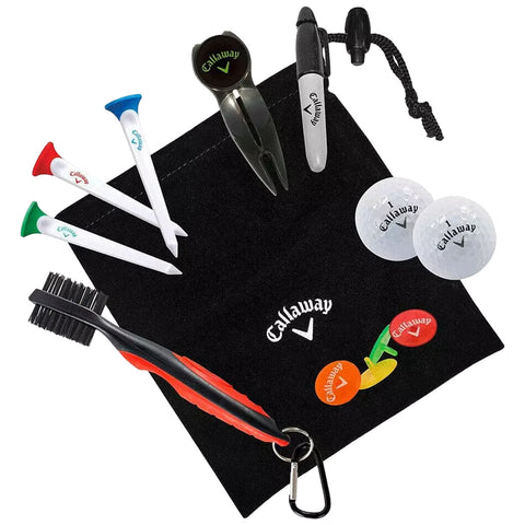 A variety of golf accessories including tees a ball marker a divot tool a brush and two golf balls are arranged on a black pouch logo visible prominently.