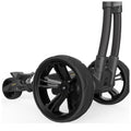 A black wheeled stroller's rear wheels are angled slightly outward while the front wheels are aligned with the frame showcasing a modern design in a minimalist setting.