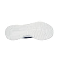 A sneaker sole rests flat showing a white rubber bottom with a textured pattern designed for grip and stability the context is a neutral background emphasizing the shoe's design