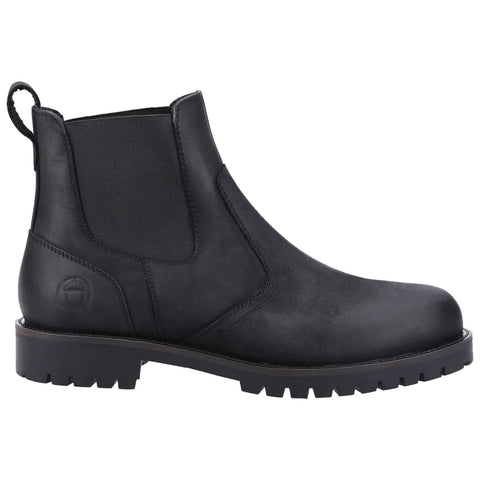 A black Chelsea boot with elastic side panels features a rugged treaded sole and a pull tab. It is designed for casual wear in urban environments or outdoor settings.