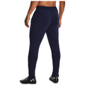 Navy athletic pants are worn by a man standing with his back to the viewer showcasing a fitted design suitable for sports or exercise in a casual indoor setting.