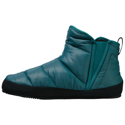 A teal padded boot with a black sole is displayed upright showcasing its quilted texture and a side zipper for easy wear in a casual indoor or outdoor setting.