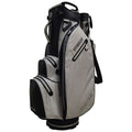 A golf bag stands upright with multiple compartments and a shoulder strap showcasing a hybrid design for carrying golf clubs and accessories in a clean and modern style.