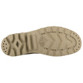 A beige shoe sole rests flat showcasing a textured pattern with grooves and treads designed for grip in various environments with branding visible on the sole's side