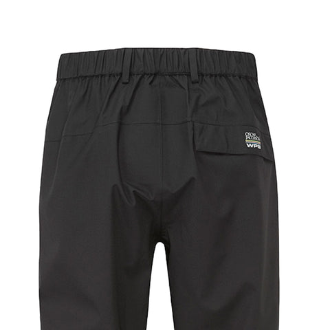 Black waterproof pants hang vertically showcasing their elastic waistband and a rear pocket with branding near the top edge in a simple undisturbed setting