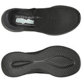 A pair of black slip-on shoes features a textured upper and a cushioned insole. The flexible rubber sole has defined grooves for traction, suitable for casual or everyday wear.