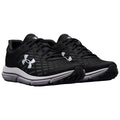 Black athletic shoes with mesh detailing are positioned side by side featuring white branding on the sides and a rubber sole suitable for running or sports activities.