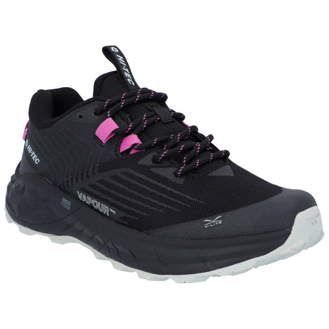 A black running shoe with pink accents is positioned prominently. It features a textured upper for grip and a chunky sole ideal for trail running, designed for outdoor activities.