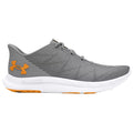 A gray athletic shoe is shown lying on its side featuring a textured design with orange accents the shoe is designed for running or training purposes