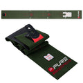 A green putting mat with alignment markings lays flat while a black and red putting aid rests on top, designed for practice in a home or indoor setting.