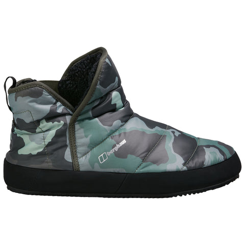 A camo-patterned slipper is shown standing upright with a soft, padded exterior and a textured black sole, designed for comfort and warmth in a cozy indoor environment.