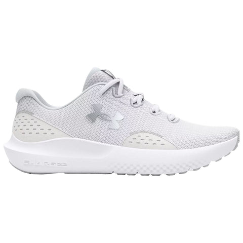 A pair of light gray athletic shoes sits displayed with a breathable mesh upper and a cushioned sole showcasing the Under Armour logo emphasizing a sleek and modern design.