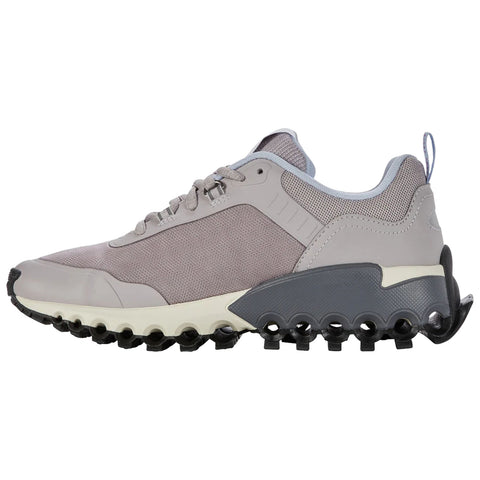 A sneaker designed with a gray mesh upper and a distinctively structured sole featuring rounded protrusions providing support and traction situated against a blank white background.