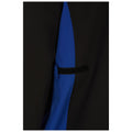 A piece of clothing featuring a combination of black and blue fabric is positioned with a Velcro strap visible on a side seam, suggesting a stylish design in a textile context.