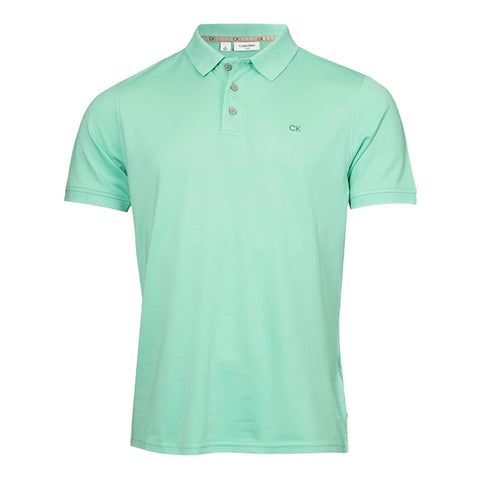 A mint green polo shirt hangs visibly showcasing its short sleeves and three-button placket with a CK logo embroidered on the left chest area against a plain white background.