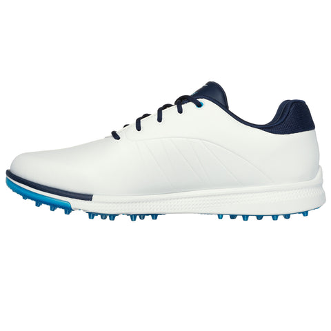 A white golf shoe sits upright with dark blue accents laces and spikes underneath showcasing a sleek design intended for performance on the golf course