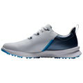 A white athletic shoe with a blue gradient is displayed sideways featuring a smooth upper texture and rubber spikes on the sole designed for traction on grassy surfaces.