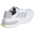 A white athletic shoe with grey accents is displayed from an angled perspective highlighting its laces cushioning and grip sole emphasizing a sleek modern design suitable for sports or casual wear